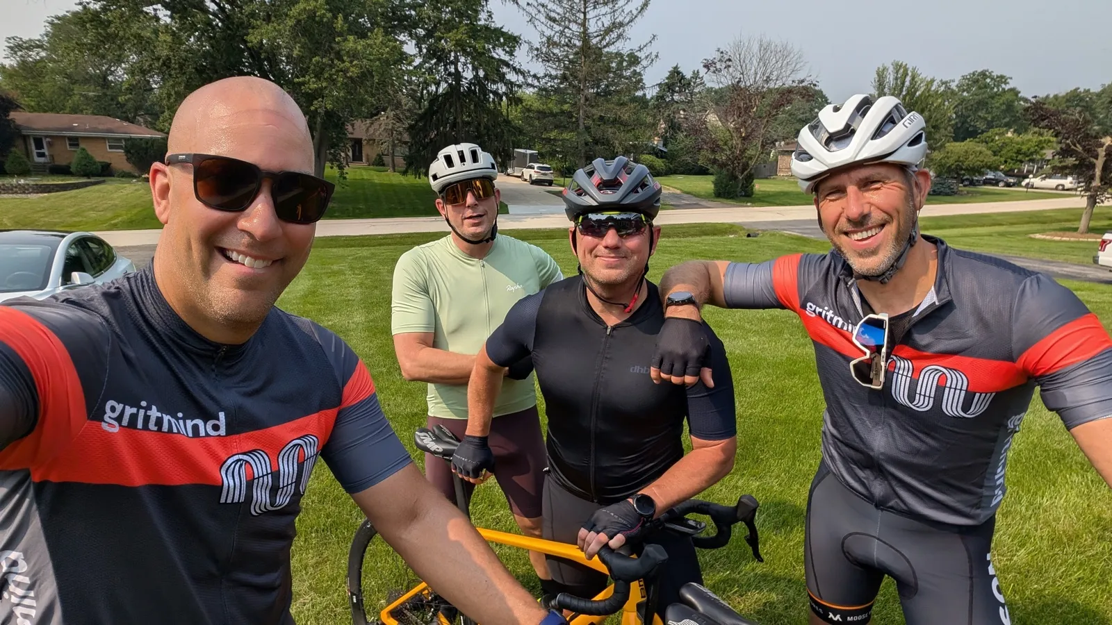 Four riders in gritmind cycling kit on a summer road ride