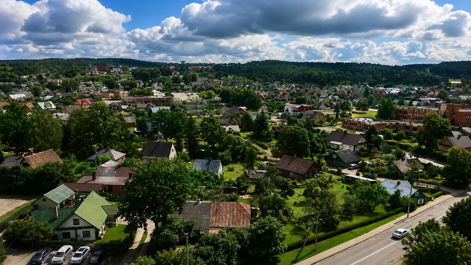 Aerial view of the town of Anykščiai, Lithuania, with red-roofed houses set among green trees