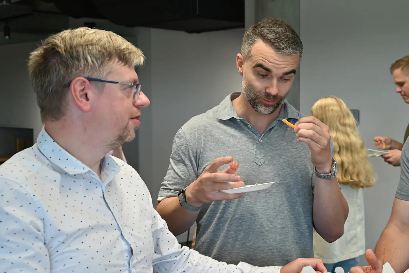Two Gritmind team members tasting hot wings at the Gritfest wing contest